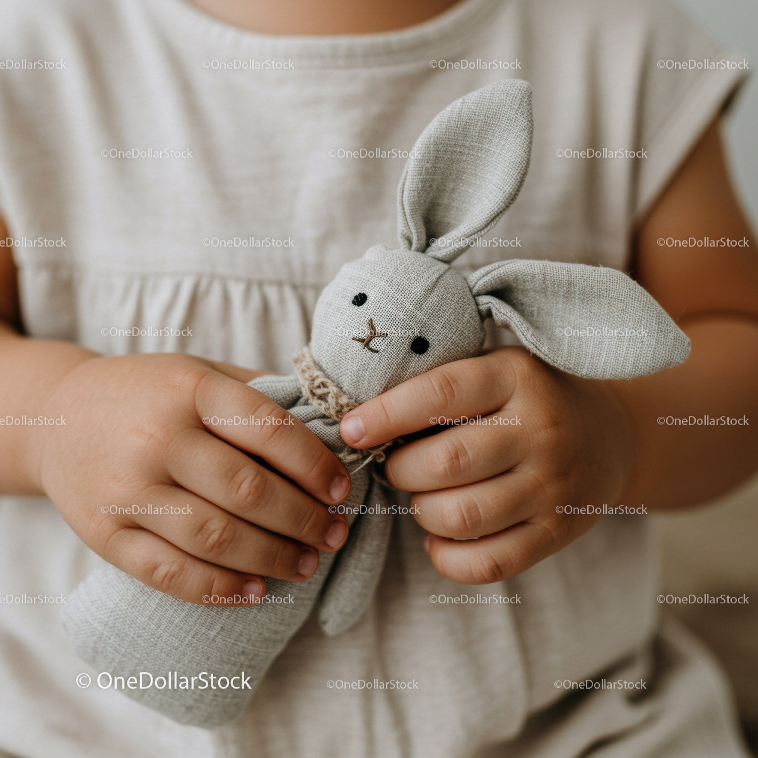 Child holding soft handmade ceramic bunny toy