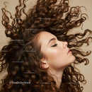 Profile of woman with voluminous curly hair flowing