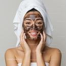 Beautiful young woman with facial mask in spa setting