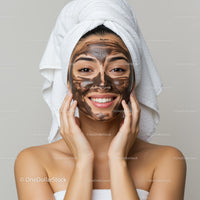 Beautiful young woman with facial mask in spa setting