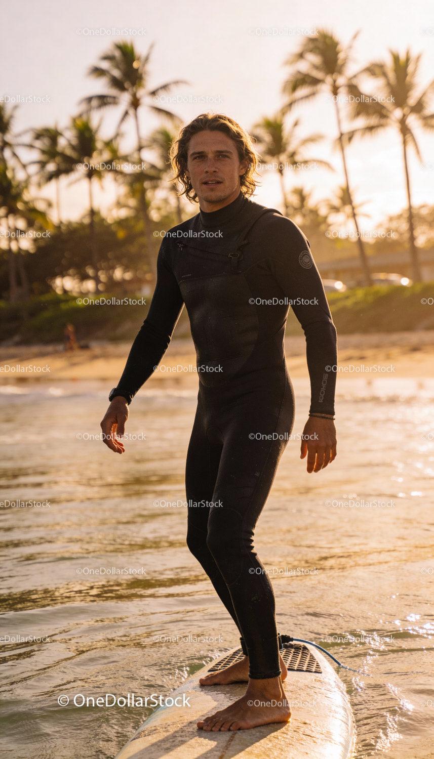 Man Wearing Wetsuit Surfing Near Tropical Beach