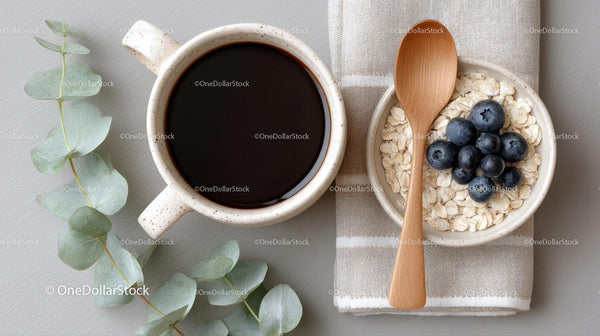 Coffee Cup and Oatmeal Bowl with Blueberries on Cozy Kitchen Table
