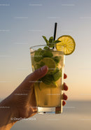 Refreshing Mojito Cocktail Held Against Sunset Sky