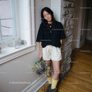 Casual Young Woman with Wildflowers Indoors Standing by the Window