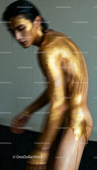 Artistic Nude Figure Covered in Flowing Gold Paint