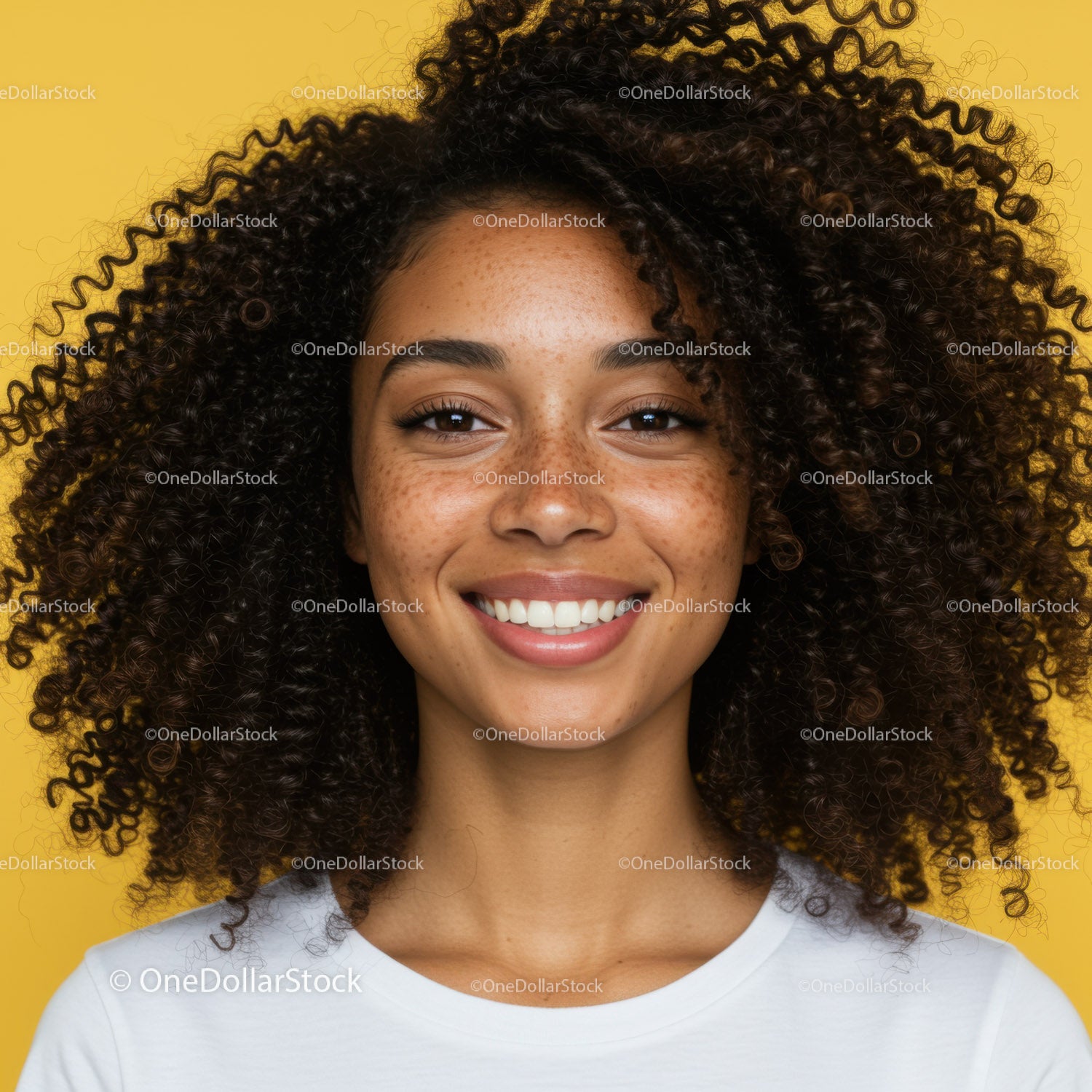 Bright Smiling Woman with Curly Hair and Freckles against Yellow Background