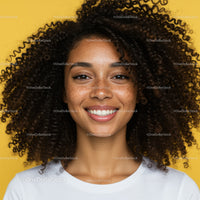 Bright Smiling Woman with Curly Hair and Freckles against Yellow Background