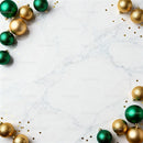 Green and Gold Christmas Ornaments on Marble Surface
