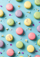 Colorful pastel macarons on bright blue background