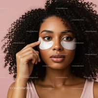 Young Woman with Curly Hair and Under Eye Gel Patches on Pink Background