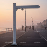 Empty Directional Sign by Seaside Promenade at Sunrise