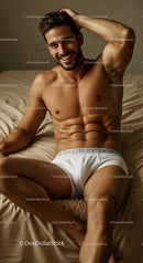 Smiling shirtless man relaxing comfortably on bed