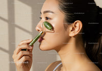 Beautiful Woman Performing Facial Massage with Jade Roller for Skin Rejuvenation