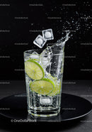 Refreshing lime slices with ice splashing in glass
