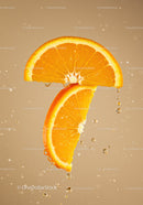 Fresh orange slices dripping with juice on beige background