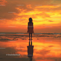 Silhouette of a Child at Sunset by the Ocean Shore