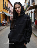 Fashionable Woman Wearing Black Hoodie in Urban City Street
