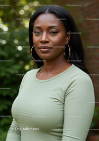 Confident woman standing outdoors with green background
