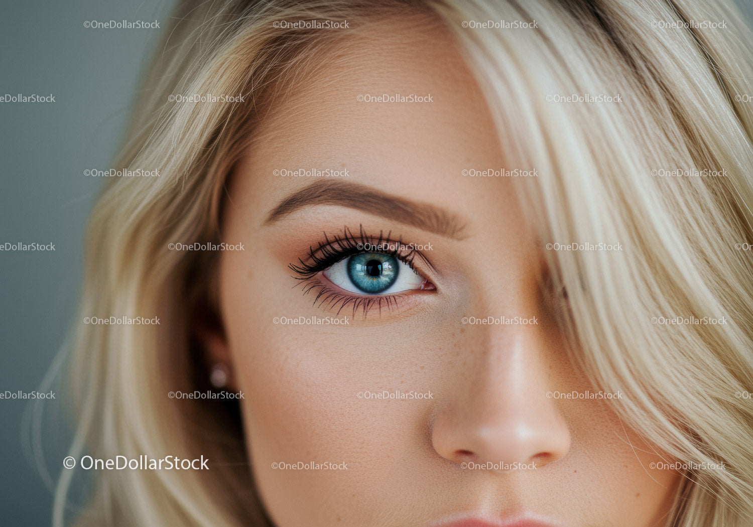 Close-up of blue eye and blonde hair with natural makeup