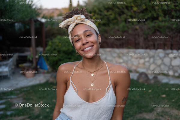 Young Woman Smiling Outdoors in Casual Summer Outfit