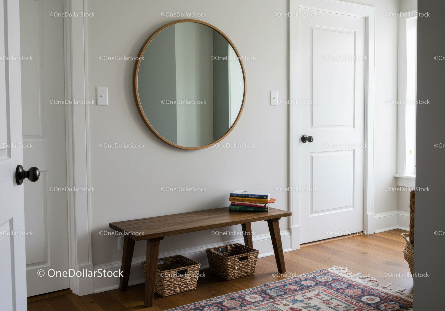 Clean White Hallway with Wooden Bench and Round Mirror