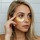 Woman in Spa Using Gold Under Eye Patches for Rejuvenation