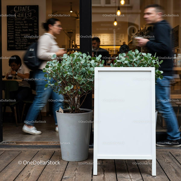 Blank white signboard outside busy cafe with green plants JPG Mockup Image