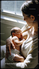 Mother Tenderly Breastfeeding Newborn by Window Light