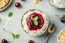 Delicious Whipped Cream Dessert with Cherry Topping and Mint