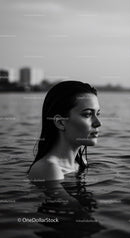 Serene Female Portrait in Water with Urban Background
