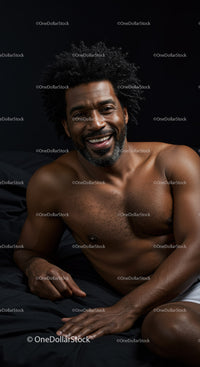Smiling relaxed man lying on bed in a dark room
