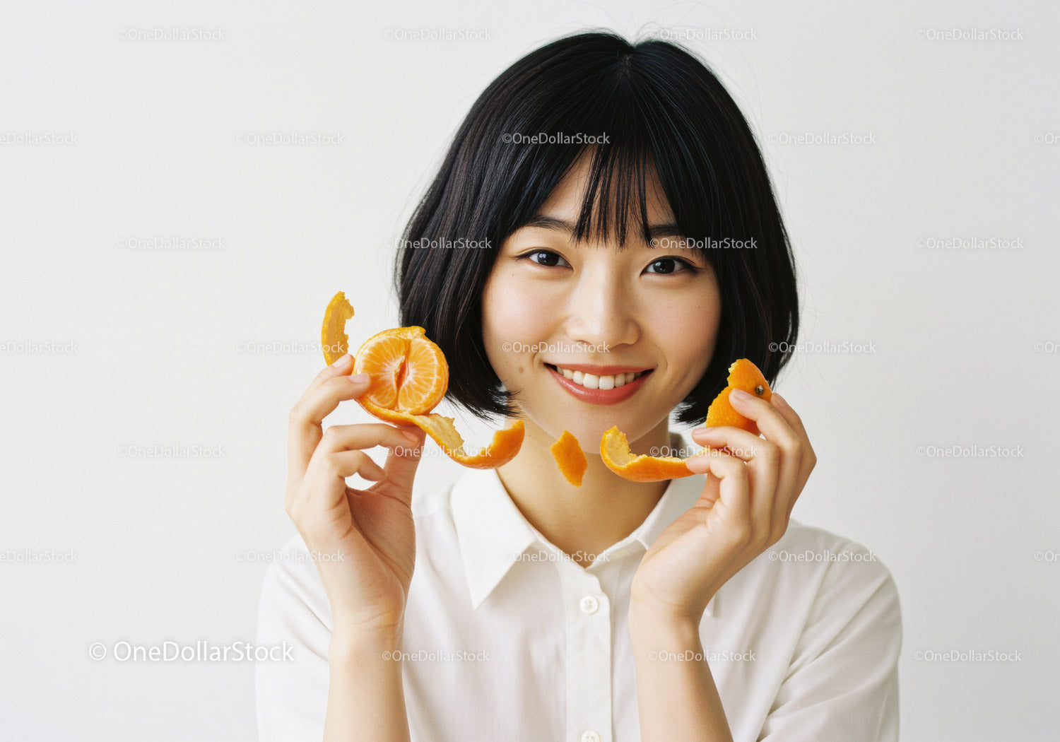 Young Woman Holding Fresh Tangerine and Orange Peel in Bright Studio