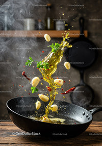 Garlic and herbs sizzling in hot oil frypan