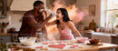 Couple Playfully Baking Heart Cookies in Cozy Kitchen
