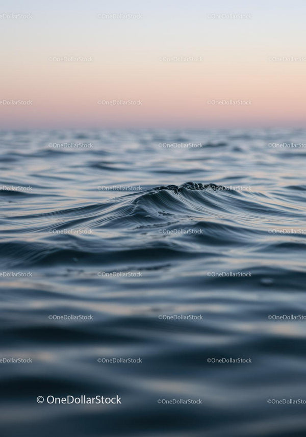 Calm Ocean Waves at Sunset with Soft Pastel Sky