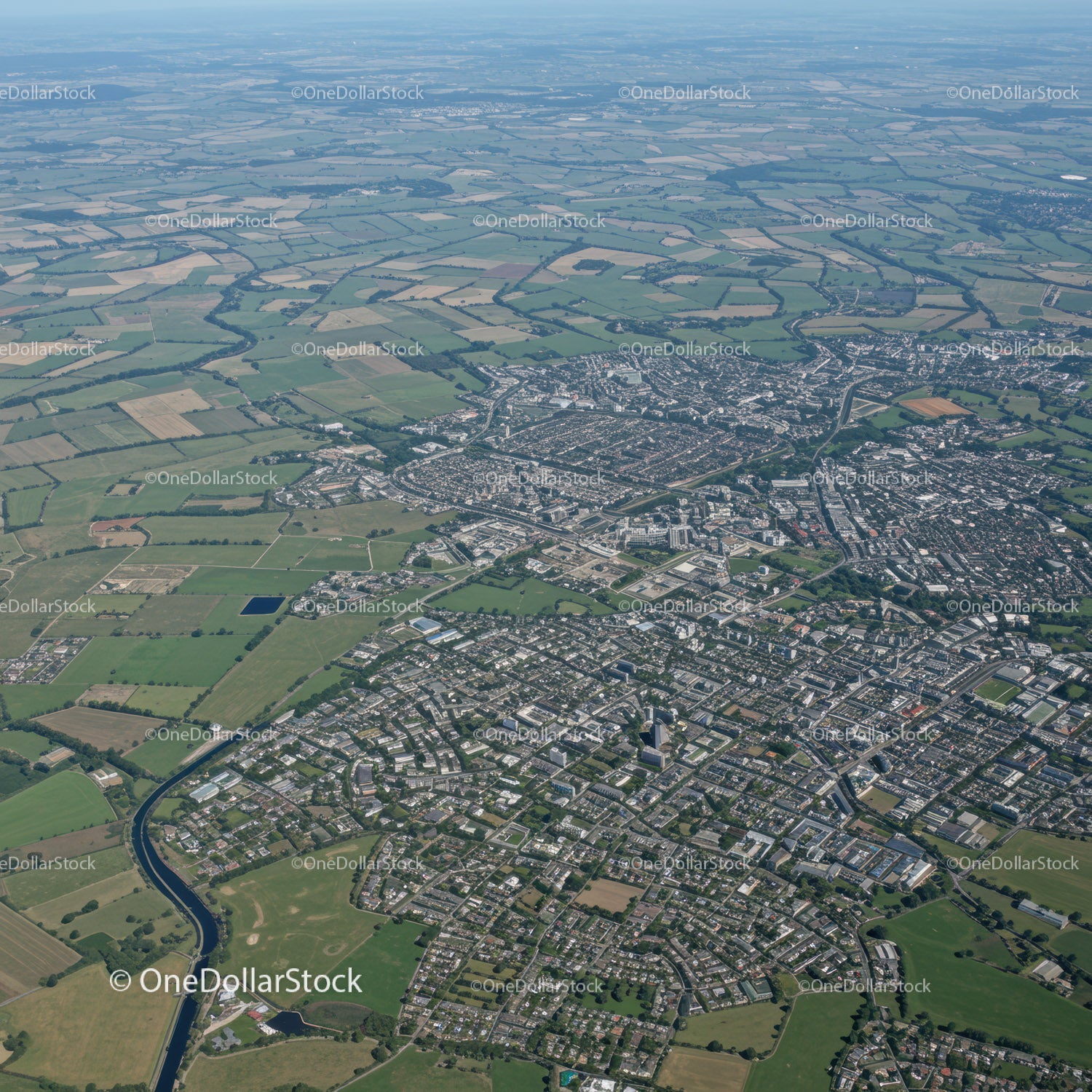 Aerial View of a Modern City with River and Green Spaces