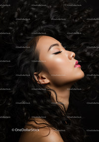 Elegant woman with flowing curly hair and flawless makeup