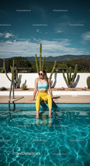 Trendy Young Woman Relaxing by the Vibrant Swimming Pool