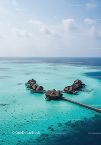 Overwater Bungalows in Turquoise Ocean Under Blue Sky with Clouds