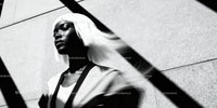 Stylish woman with white hair in dramatic light and shadow