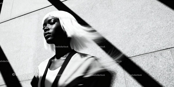 Stylish woman with white hair in dramatic light and shadow
