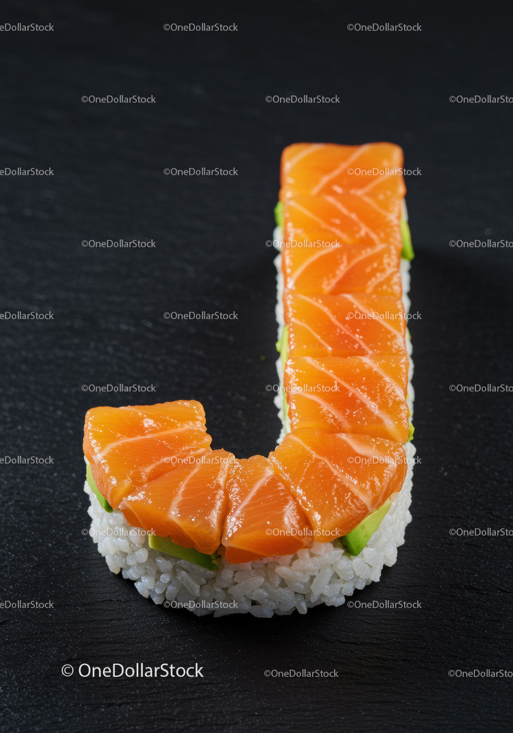 Sushi shaped as letter J with fresh salmon slices