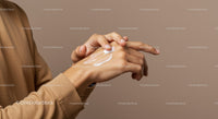 Close-Up of Hands Applying Moisturizer with Soft Skin and Neutral Background