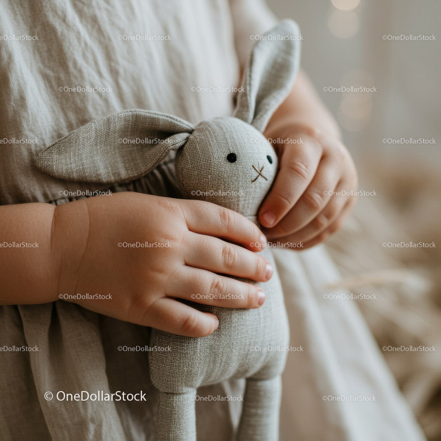 Toddler Holding Soft Gray Linen Bunny Toy