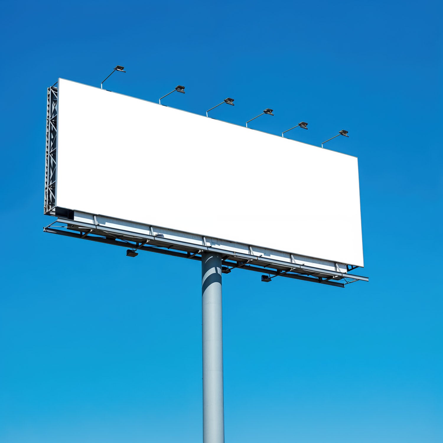 Large blank billboard against clear blue sky
