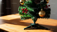 Close up of decorated artificial Christmas tree on wood table
