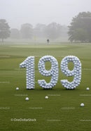 Golf Balls Arranged in Numbers on Misty Golf Course
