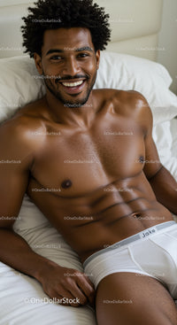 Smiling man relaxing on bed in white underwear