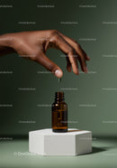 Hand Holding Dropper Above Amber Glass Bottle for Skincare or Medicine