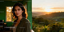 Thoughtful woman standing indoors with sunset outside